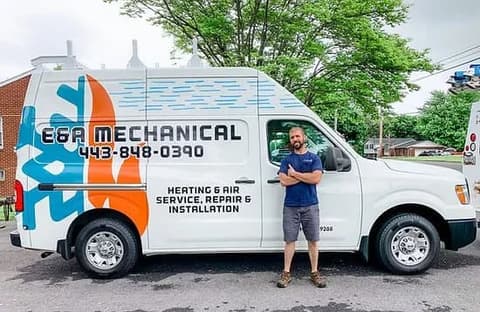 E&A Mechanical owner Mike beside the rear of the wrapped company van