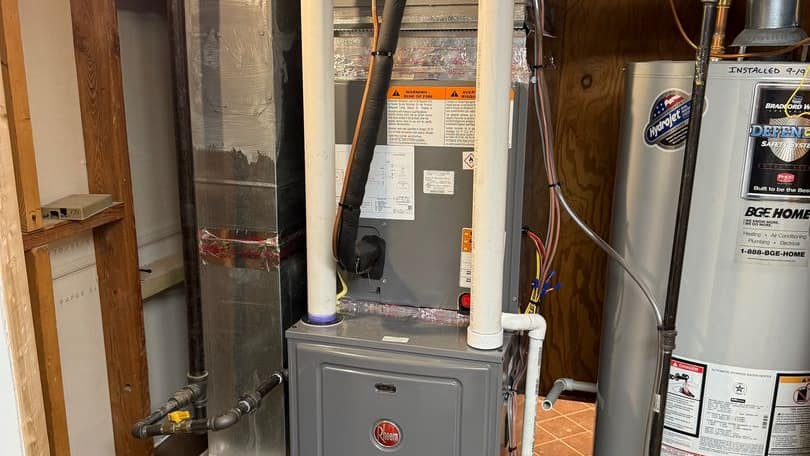 Rheem furnace and water heater installed together in a basement corner