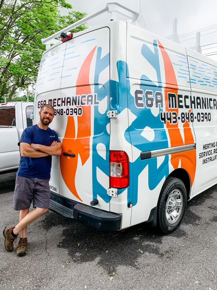 E&A Mechanical owner Mike giving a thumbs up beside the wrapped company van